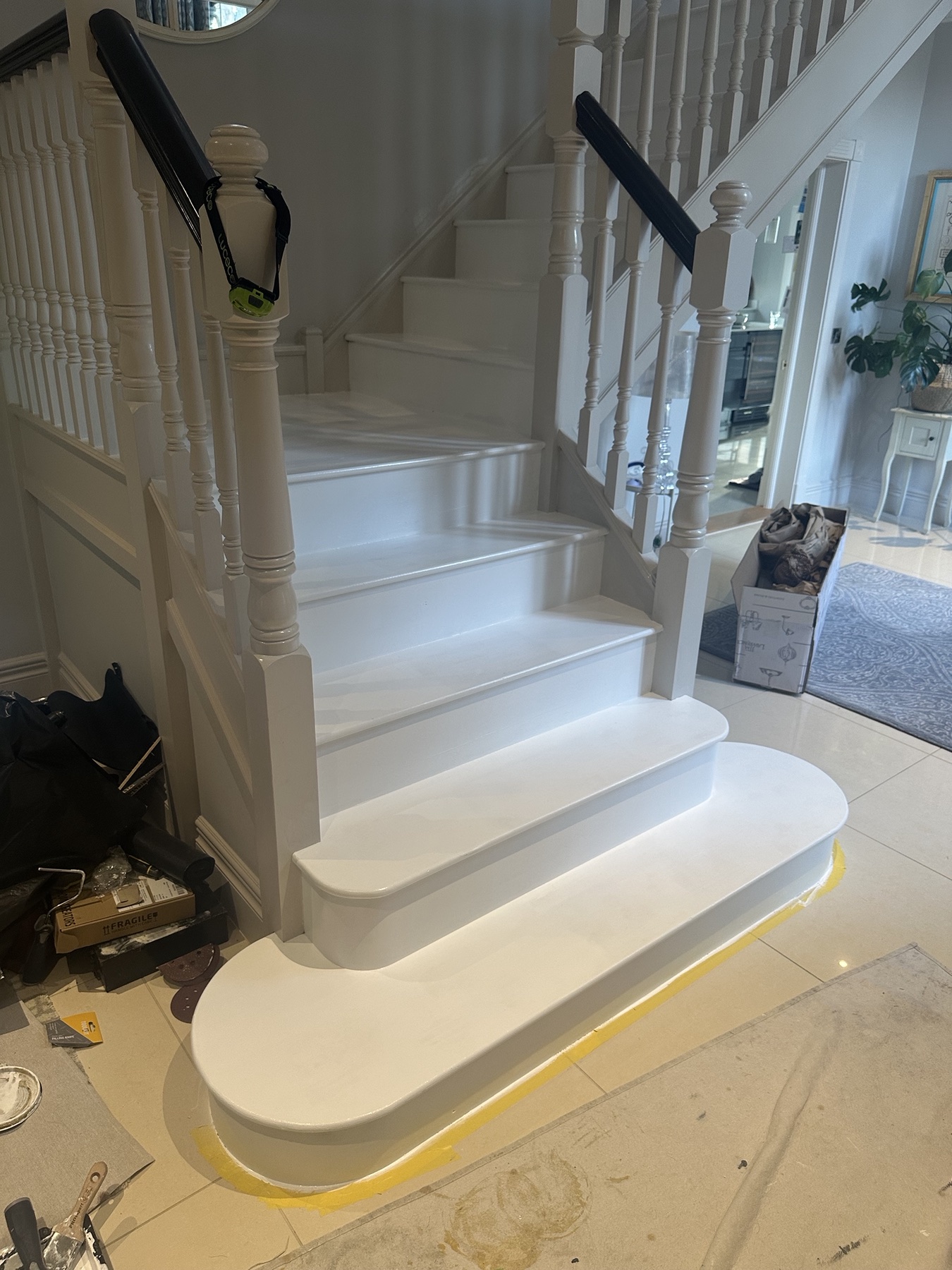 Freshly painted white stair tread after preparation work